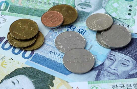 South Korean won money banknotes and coins on table. South Korea cash bills of KRW currency