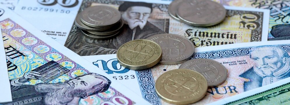 Icelandic krona money banknotes and coins on table. Iceland cash bills of ISK currency