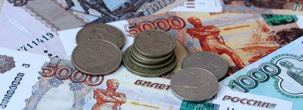 Russian rubles old money banknotes and coins on table. Russian cash bills of RUB currency