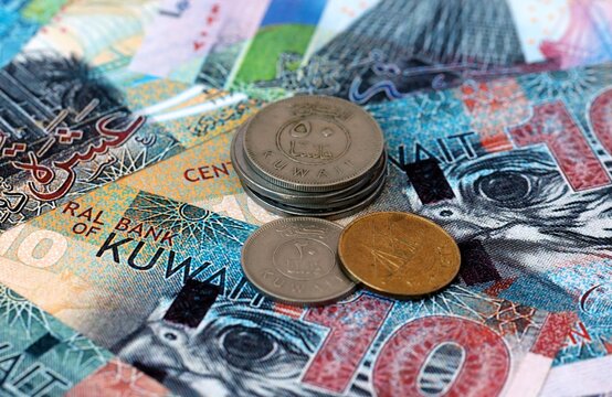 Kuwaiti dinar money banknotes and coins on table. Kuwait cash bills of KWD currency