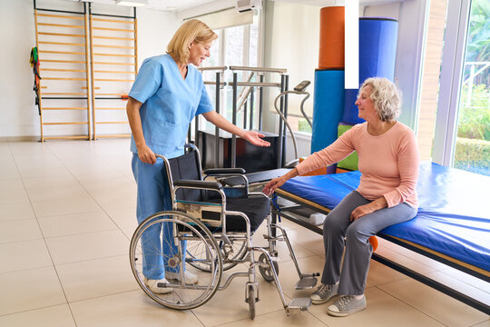 Senior Woman With Physiotherapist At Rehab Center Wheelchair Assistance For Mobility And Recovery After Injury Indoor Rehabilitation Session