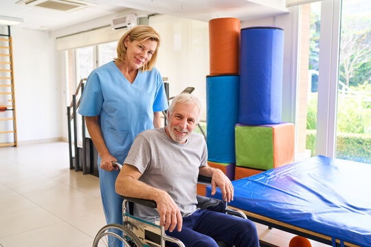 Senior Man in Wheelchair with Physiotherapist in Rehab Center Indoor Recovery Session Medical Care and Assistance Rehabilitation Programs