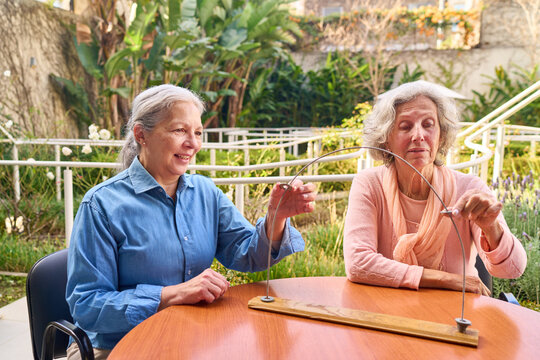 Senior Women Doing Motor Skill Therapy Exercise Outdoors At Rehab Center For Brain Injury Recovery And Improved Coordination And Dexterity