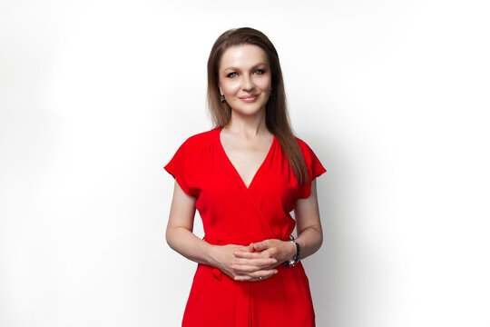 Young smiling girl in red dress isolated on white background.