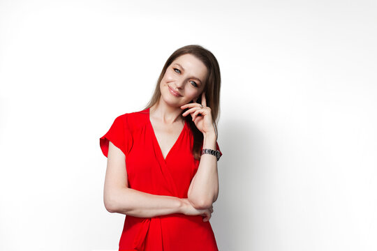 Young happy girl in red dress isolated on white background.