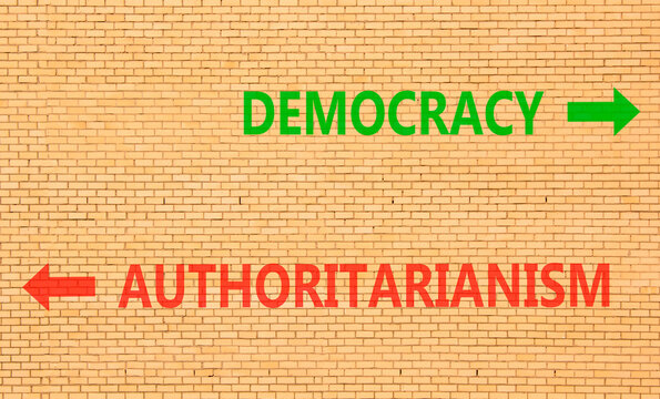 Democracy or authoritarianism symbol. Concept words Democracy Authoritarianism on beautiful brick wall. Beautiful brick wall background. Business democracy authoritarianism concept. Copy space