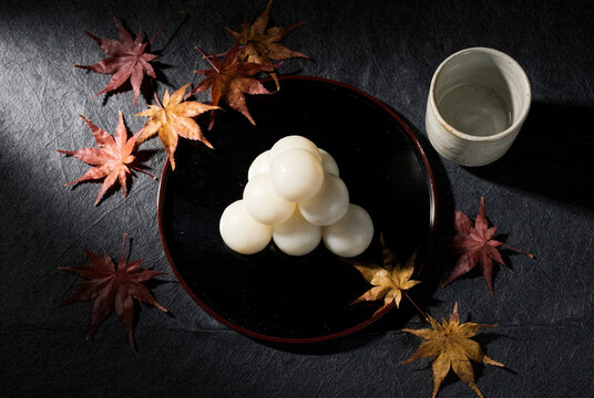 Traditional Japanese Tsukimi Dango with Autumn Maple Leaves