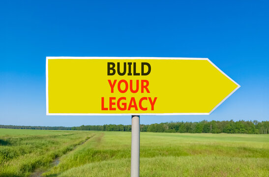 Build your legacy words symbol. Concept words Build your legacy on beautiful yellow road sign. Beautiful blue sky green grass background. Business build your legacy concept. Copy space.