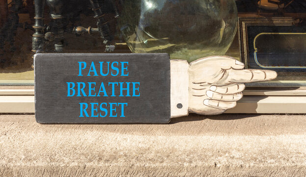 Pause breathe reset symbol. Concept words Pause breathe reset on beautiful black information sign. Beautiful shopfront background. Business support motivational pause breathe reset concept. Copy space