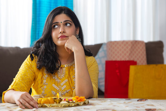 A YOUNG WOMAN SITTING AND WAITING TO CELEBRATE RAKSHABANDHAN