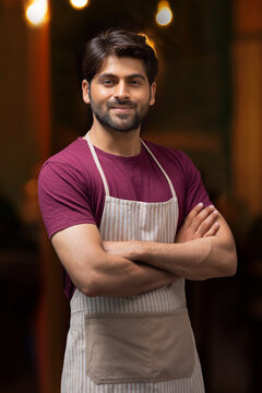PORTRAIT OF A CONFIDENT WAITER POSING IN FRONT OF CAMERA