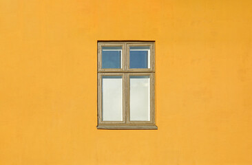 Fototapeta premium Minimalist facade showing window on yellow wall