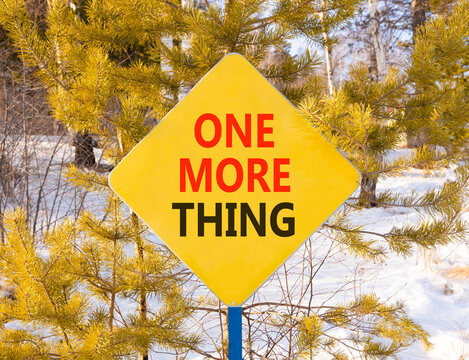 One more thing words symbol. Concept words One more thing on beautiful yellow road sign. Beautiful winter forest background. Business and one more thing concept. Copy space.