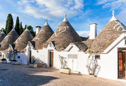 wonderful white mediterranean architecture of italian buildings with sdtrange conic roofs and wfite vintage walls and windows