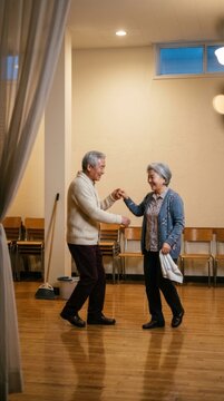 Elderly couple dancing together in warm indoor community setting at a gathering