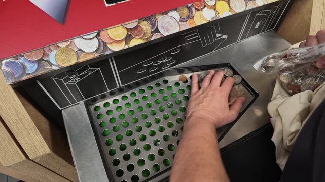 Woman Feeds Coins Into Supermarket Coin Sorter Device Outdoors