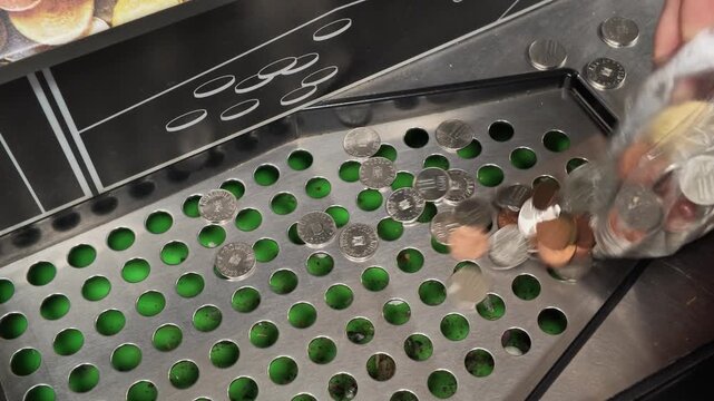 Woman Empties Coins Into Coin Sorting Machine at Store Today