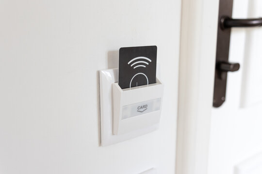 key card inserted into hotel room energy saver switch holder