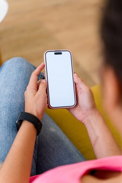 Hispanic Person holding a smartphone with a blank screen
