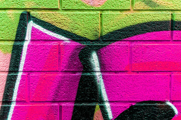 Beautiful brick wall colorful street art graffiti background. Abstract creative spray drawing fashion colors painting on the walls of the city. Urban Culture, aerosol texture © Yaroslav