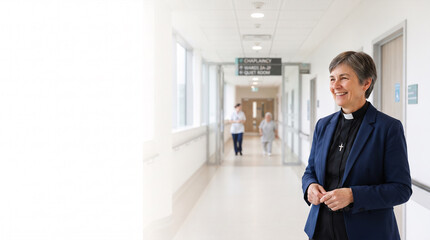 Fototapeta premium Clergywoman in clergy attire smiling in hospital corridor with patients blurred in background