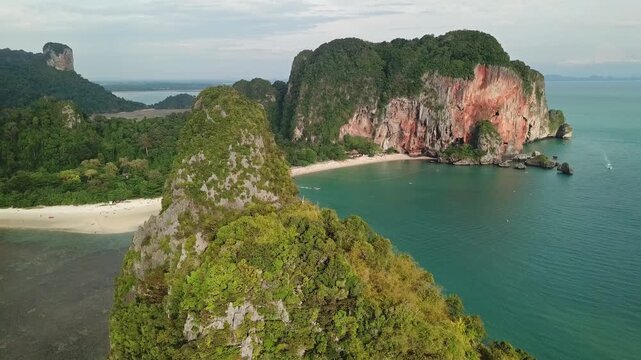 Aerial view of Railay Beach with dramatic limestone cliffs, lush greenery, and turquoise water along the coast in Ao Nang, Krabi, Thailand.
