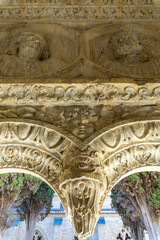 An intricately carved stone corbel features detailed medieval reliefs © wundermann