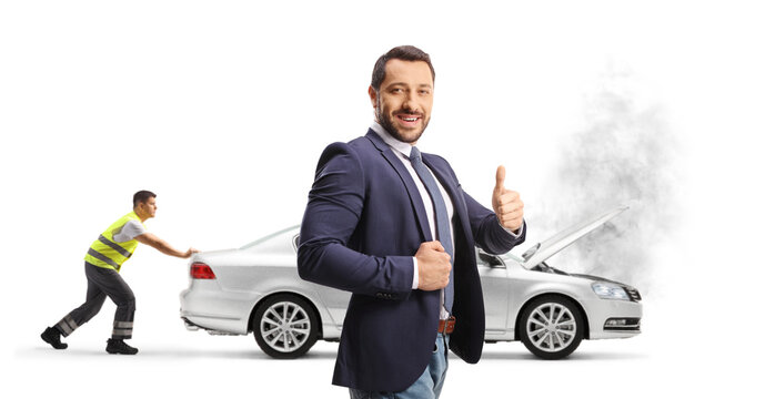 Man gesturing thumbs up and a road help worker pushes broken down car