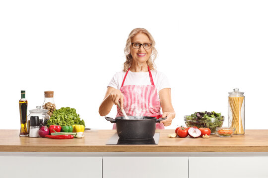 Woman cooking food in a pot on a kitchen counter