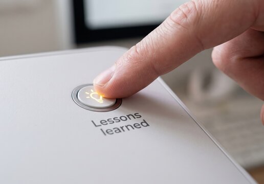 Lessons Learned text button indicator, hand finger pressing white device, modern office business report concept, workflow analysis review, decision making