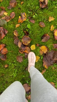 Close-Up of Woman Walking Through Autumn Leaves in Motion