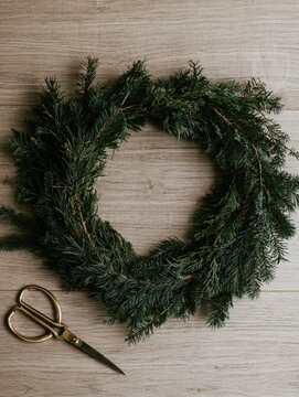Dark evergreen wreath mockup detailed top down still life