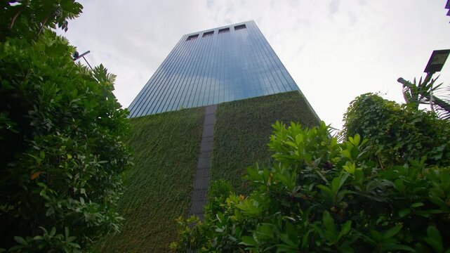 Innovative eco friendly architecture with tree covered skyscrapers transforming the Singapore city skyline into a sustainable urban destination in Asia 
