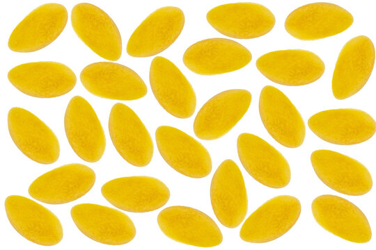 Pattern of yellow oval-shaped fusca slices arranged on a light wooden background, top-down view of fruit pieces