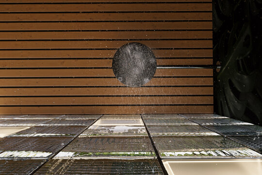 3d Rendering of a modern shower room with glass cubes wall and shower head from below