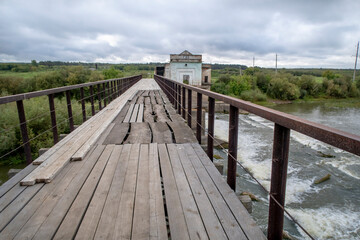 Fototapeta premium View of the dam of the abandoned Kiik Hydroelectric Power station under a stormy sky