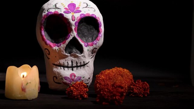 Calavera sugar skull centerpiece for Day of the Dead celebration with candles and marigolds