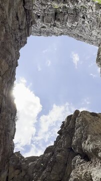 Dramatic High-Altitude Vertical Footage Spinning Upwards from a Snowy Crater Towards the Vast Blue Firmament on a Mountain Top