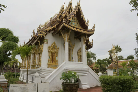 traditional oriental white palace hall featuring ornate gold roof gables detailed window frames and symmetrical stone staircase