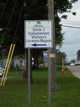 Gatineau, Quebec, Canada &ndash; June 28, 2026: A "Ville de Gatineau" sign directs visitors to Entrance 3, visitor parking, and store deliveries pointing left  on Bd Saint-Ren&eacute; E.