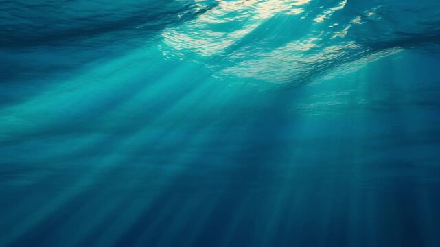 Underwater sunbeams piercing calm ocean surface with tranquil light rays creating serene natural background