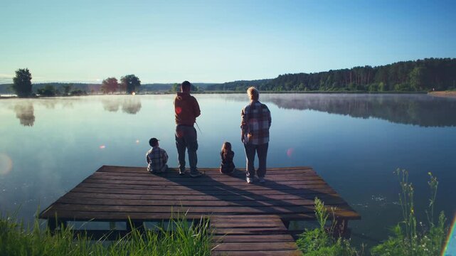 Family fishing together on a peaceful lake