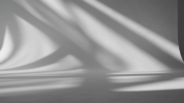 Abstract play of light and shadow on a smooth curved white wall indoors