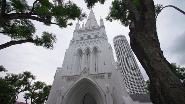 Historic Saint Andrews Cathedral rising above Singapore downtown with elegant Gothic architecture colonial heritage and iconic urban scenery for tourism in Asia 