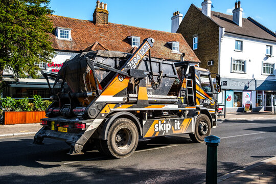 Close-Up Of A Skip It Skip Hire Lorry Driving On A Town Centre Main Road
