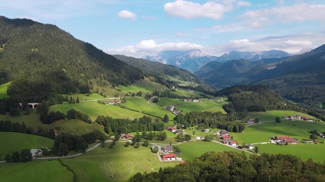 Aerial drone view of the idyllic Bavarian Alps near Ramsau bei Berchtesgaden, Germany, featuring lush green alpine meadows, narrow country roads and mountain scenery. Slow, smooth and relaxing