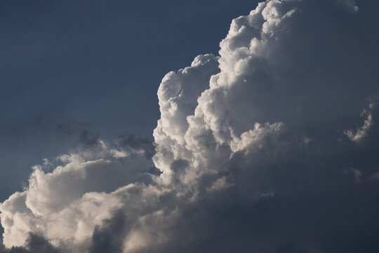Dark clouds form in the sky during the late afternoon, covering part of the city. The clouds create a dense and layered appearance with varying shades of gray