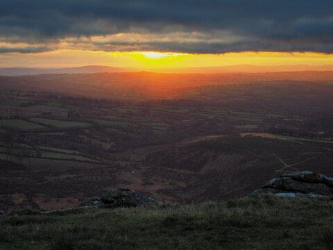 Stunning sunset from Brats Tor looking over north Devon with the church of St Michael de Rupe on top of Brent Tor in the distance, Dartmoor National Park, Devon, UK