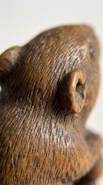 Detailed Macro of Antique Japanese Carved Wooden Netsuke Figurine with Fine Fur Texture