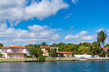 Fototapeta premium Miami beach building. Residential apartment in waterfront city. Waterfront landscape with house. Vacation building in summer. Luxury waterfront house. Hotel building. Residential architecture